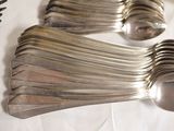 a lot of silver spoons and forks on a table