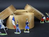 several figurines of men in military uniforms are displayed in a wooden box