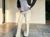 a woman that is standing on the sidewalk with her hands on her hips