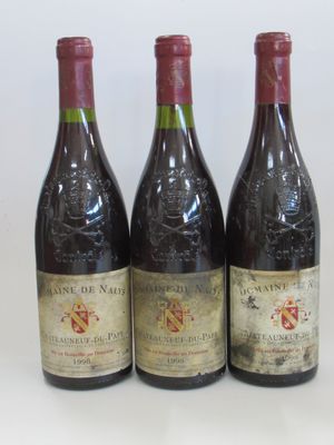 trois bouteilles de vin sont alignées sur une surface blanche