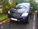 a black car parked on the side of the road