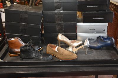 many pairs of shoes on a table in a store