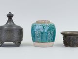 three different vases sitting next to each other on a table