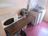 a microwave and a sink in a small room