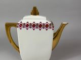 an image of a white and gold teapot with a red and white design on it