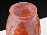 an orange vase with a picture of a cat on it