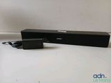 an image of a black speaker sitting on top of a white table