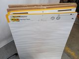 a stack of folders sitting on the floor next to a laptop