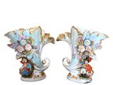 two vases that are decorated with flowers on them