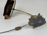 a small metal object that is attached to a cord