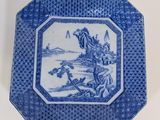 an old blue and white plate with a picture of a man on a horse