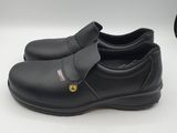 a close up of a pair of black shoes on a white surface