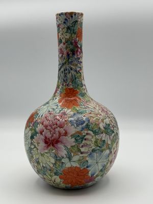 a vase with a floral design on it sitting on a table