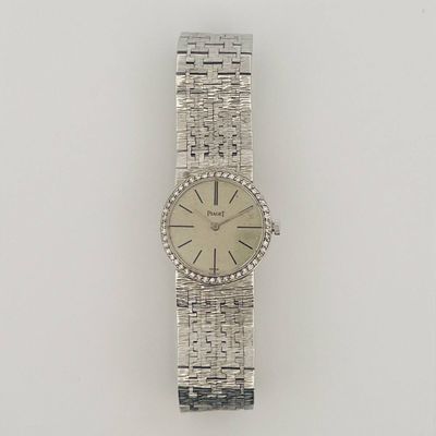 a close up of a watch on a white surface