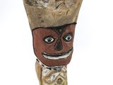 wooden figurine of a man with a hat on his head