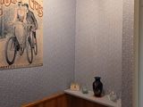 a bathroom with a toilet and a picture on the wall