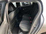the back seat of a car with the door open and the driver ' s seat down