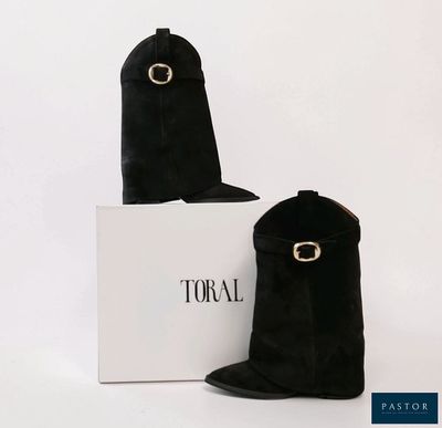 two pairs of black sued boots with a white box on a white surface