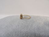 a close up of a gold ring on top of a cushion