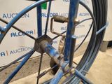 a blue bicycle wheel with a chain attached to it