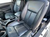 the interior of a truck with black leather seats and a steering wheel