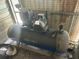 a small air compressor sitting in the corner of a room