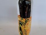 a glass vase with a black and yellow design on it
