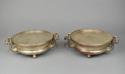 pair of silver plated bowls with handles