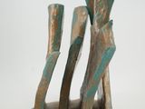 a bronze sculpture of a man and a woman on a rock