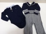 a baby boy ' s outfit and a baby boy ' s shirt on a table