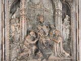 an image of a metal relief of a man and a woman in a church