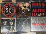 several posters of the band kiss are displayed on a wall