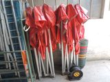several red umbrellas are lined up against a wall in a warehouse