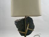 an image of a table lamp with a rock on it