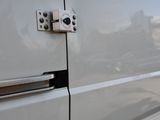 a close up of a door handle on a white van