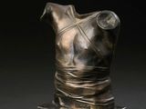 bronze bust of a female torso on a marble base
