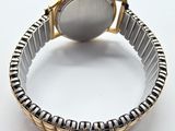 an image of a close up of a wrist watch on a white surface