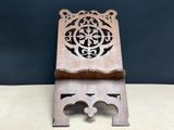 an image of a wooden stand with a carved design on it