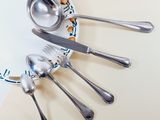 a plate with spoons and silverware on it