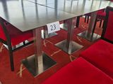 a table and chairs in a room with a lot of windows