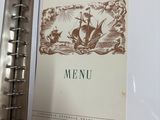 a picture of a menu in a binder on a table