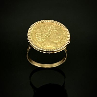 l'image d'un anneau d'or surmonté d'une pièce de monnaie