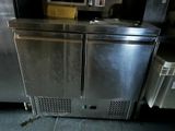a stainless steel refrigerator in a commercial kitchen