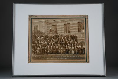 an old photo of a group of people standing in front of a building