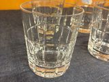 four glasses sitting on a table next to each other
