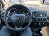 the steering wheel of a car with a person sitting in the driver ' s seat