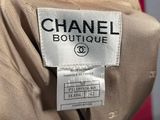 a close up of a chanel label on a beige suit