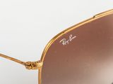 a close up of a pair of sunglasses on a white surface