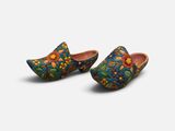 a pair of wooden clogs with floral designs on them