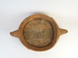 a wooden bowl with a wooden handle on a white surface